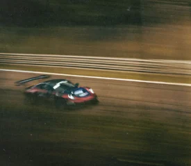 Race car speeding down open road