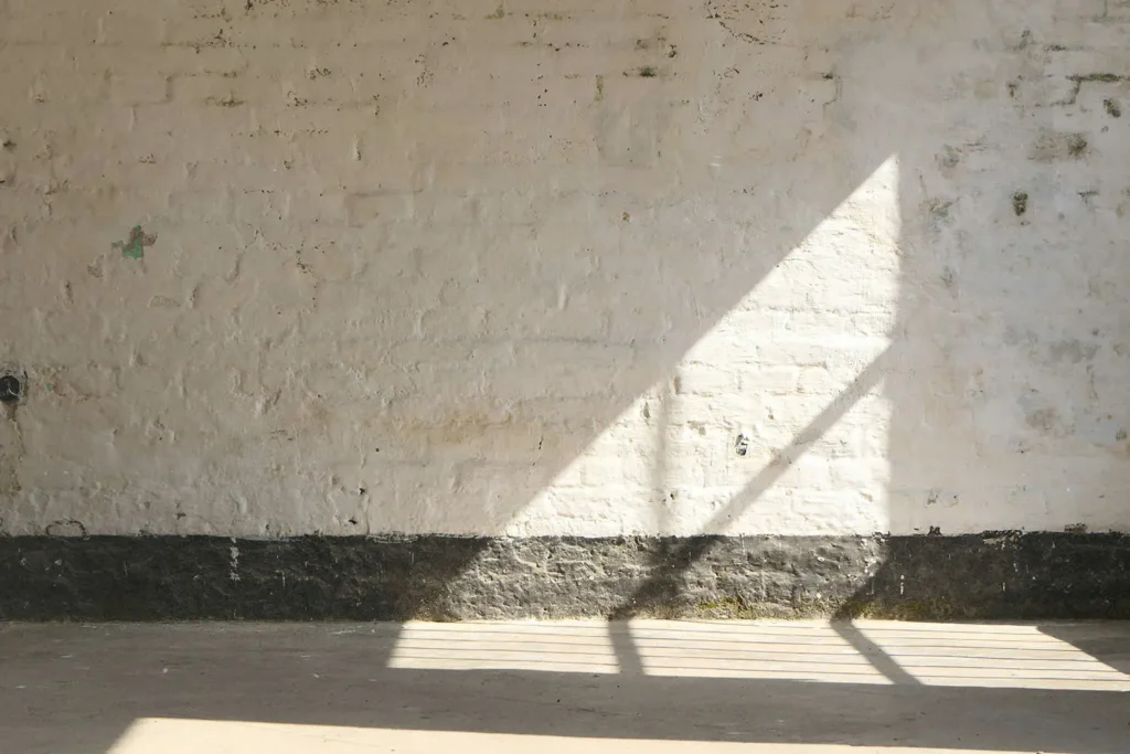 Shadow of window panes on a concrete wall