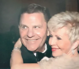 Gloria Copeland hugging Kenneth Copeland's neck
