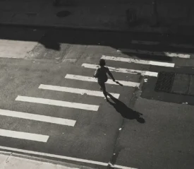 Aerial view of woman walking on crosswalk