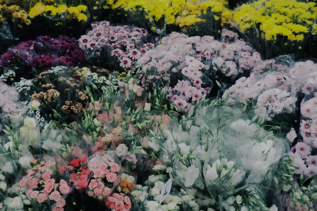 Assorted bouquets of colorful flowers, including pink, yellow, white, and purple blooms
