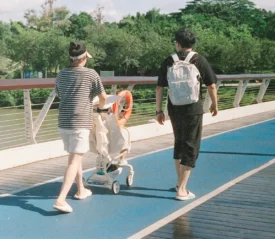Couple walking pushing a baby carriage