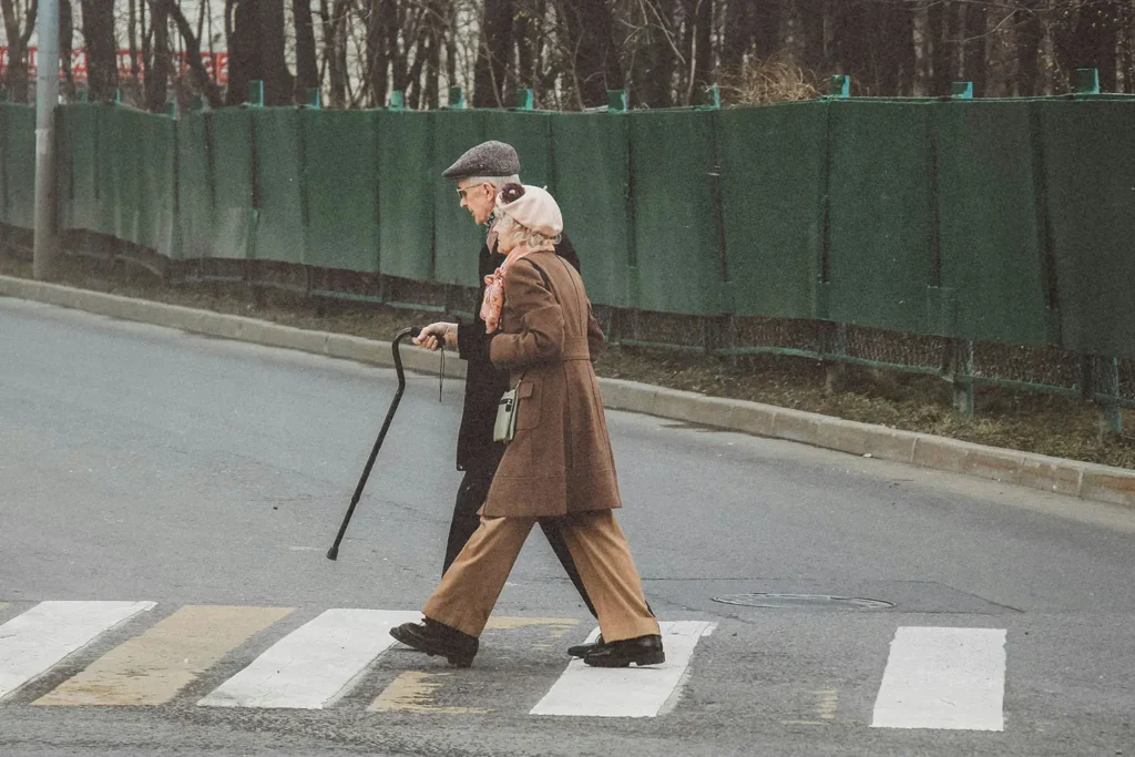 Elderly couple crossing the street on crosswalk