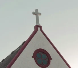 Steeple of a small church with a white cross on top and a circular stained‑glass window, set against a pale sky