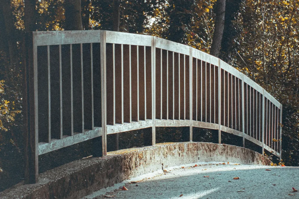 Metal railing with a concrete sidewalk