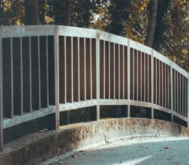 Metal railing with a concrete sidewalk