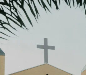 Cross sign on top of building roof