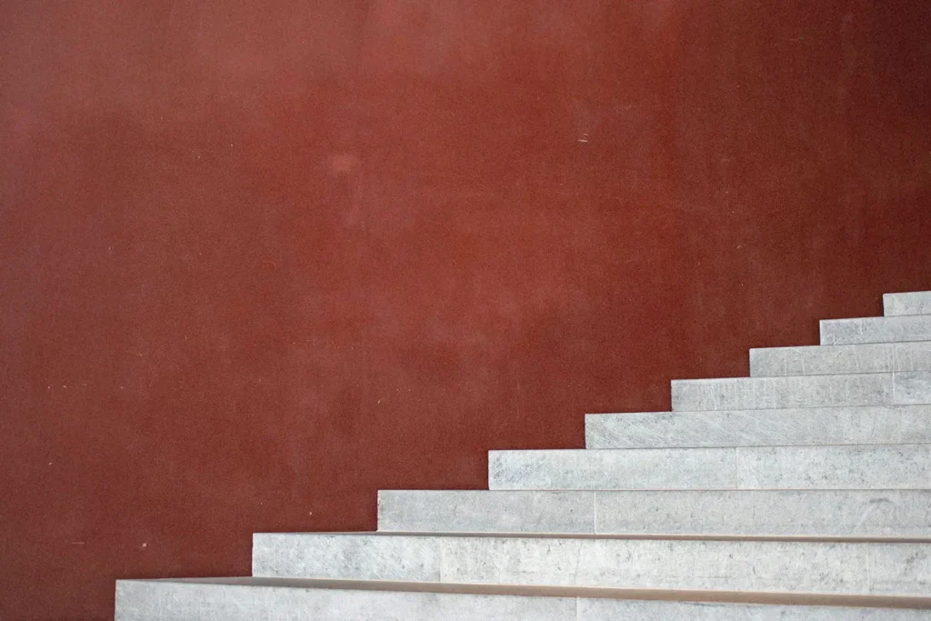 Burgundy background with white staircase