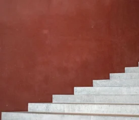Burgundy background with white staircase