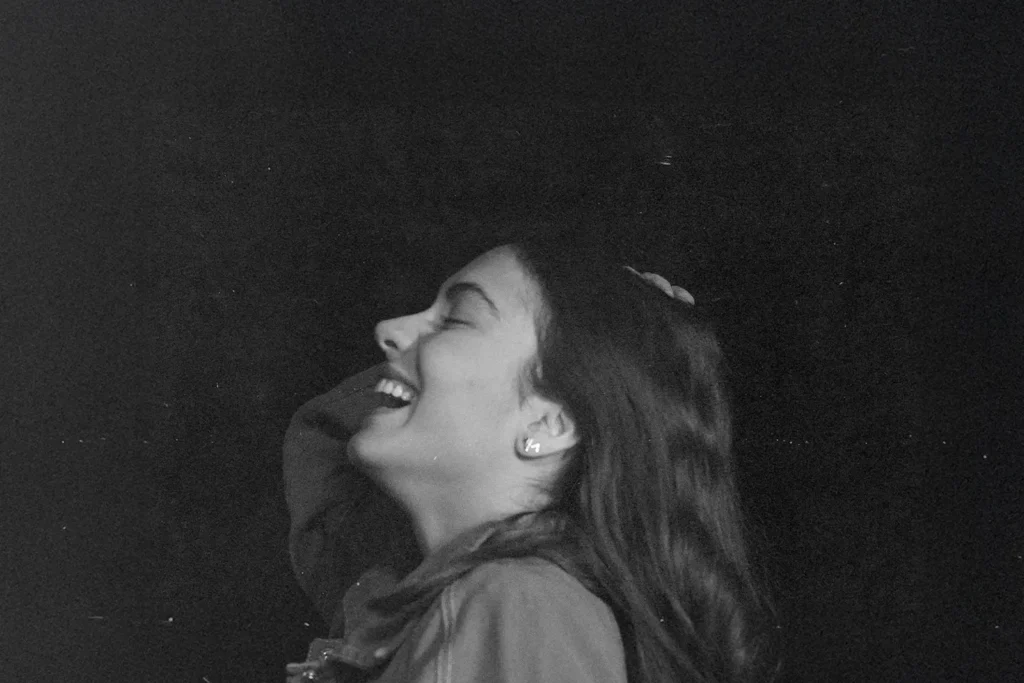 black and white photo of girl laughing