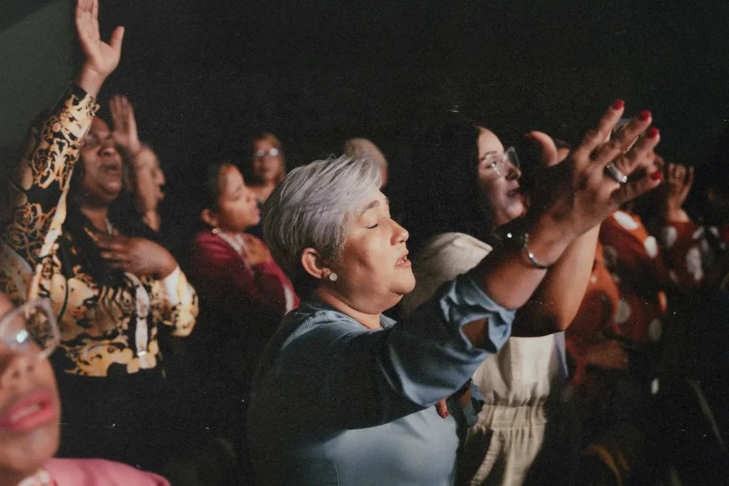 Woman with eyes closed and lifted hands in worship