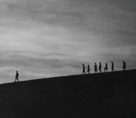 Person walking ahead leading a group of people