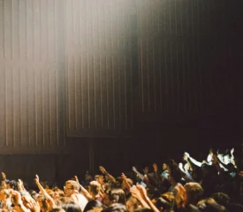 crowd of people with their hands raised in worship