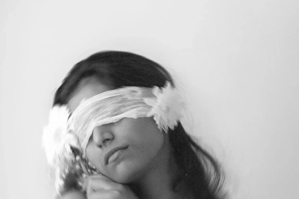 Woman with a cloth covering her eyes