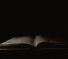 Dim light shining on an open Bible