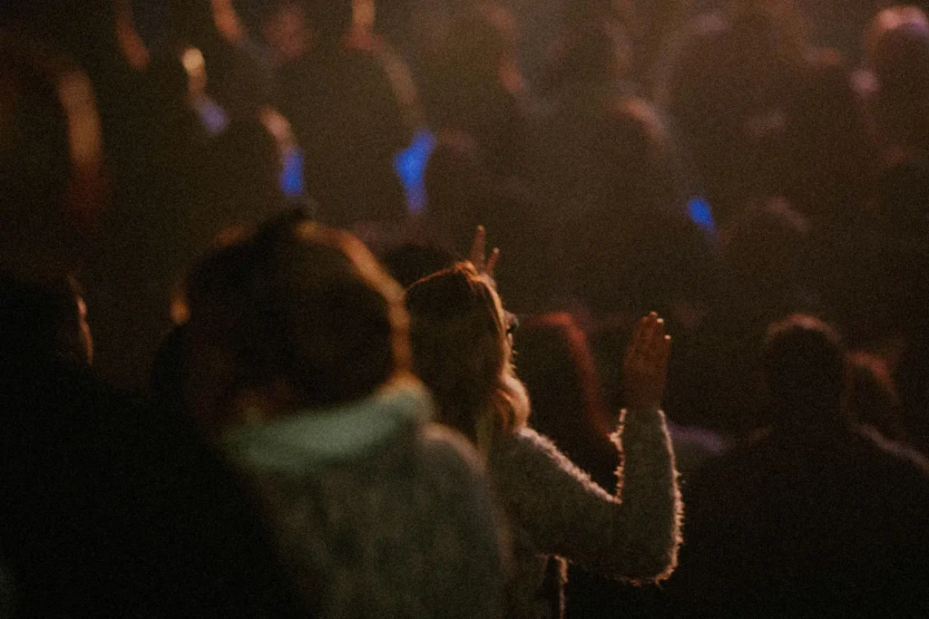 crowd with hands raised in worship