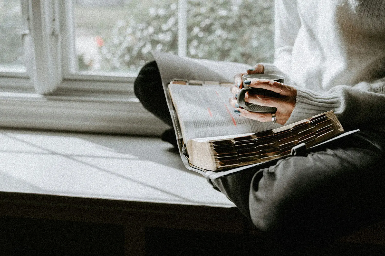 woman studying the bible over coffee