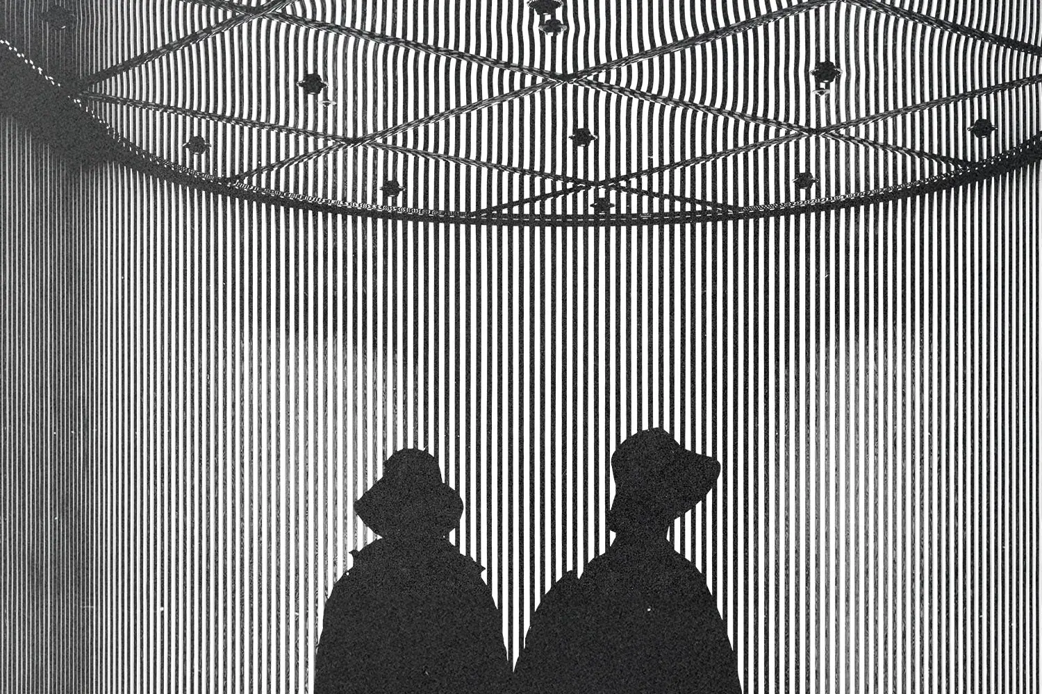 Silhouettes of two people standing beneath a striped, geometric installation with dramatic lighting