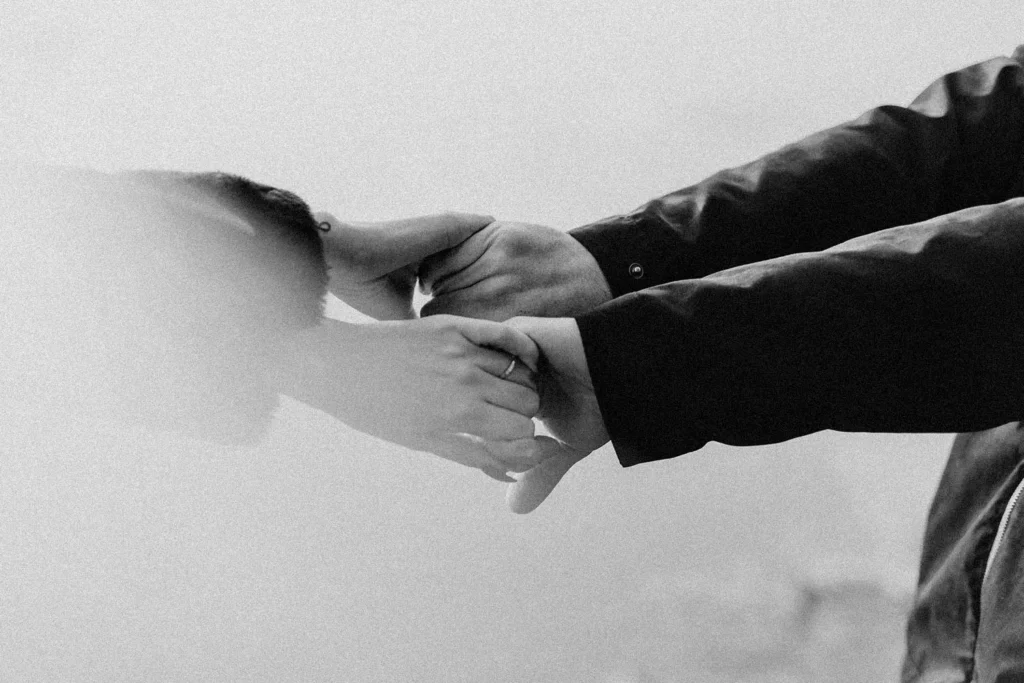 Two people grabbing each others' hands