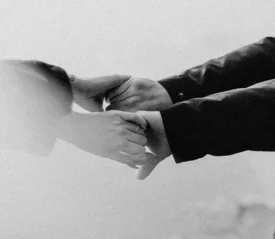 Two people grabbing each others' hands