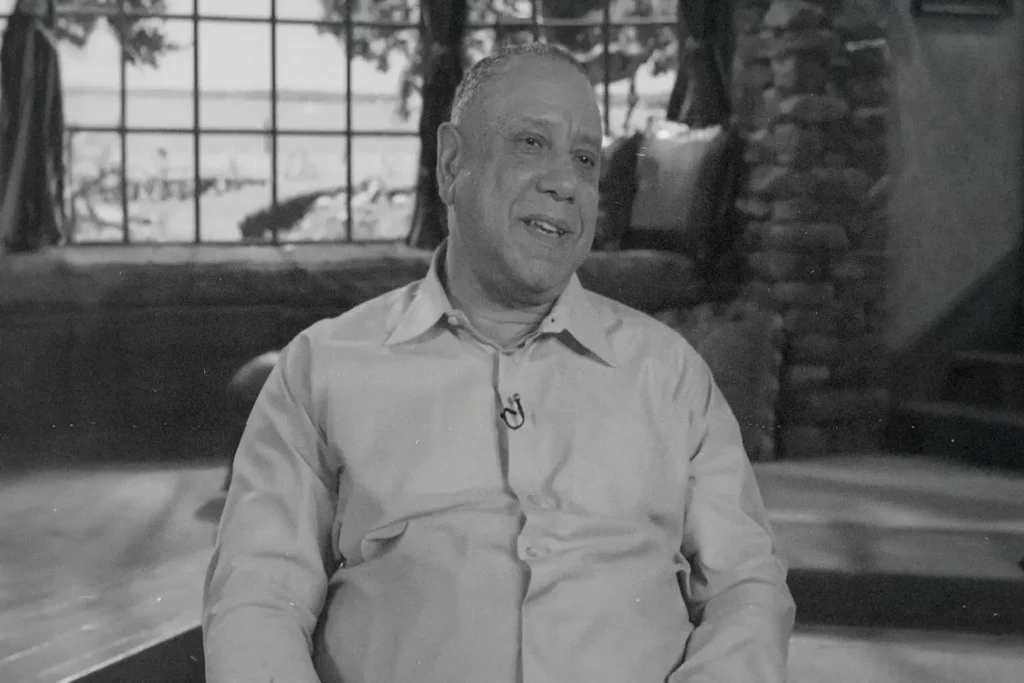 Robert Scales sitting in the Believer's Voice of Victory Broadcast studio