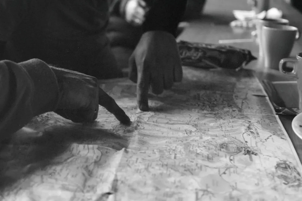 two hands pointing to a map