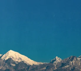 View of snowy mountains with a clear blue sky in the background