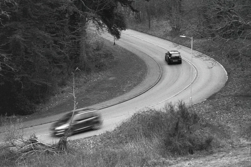 Two cars driving along a curved road