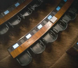 Row of college lecture room chairs and desks