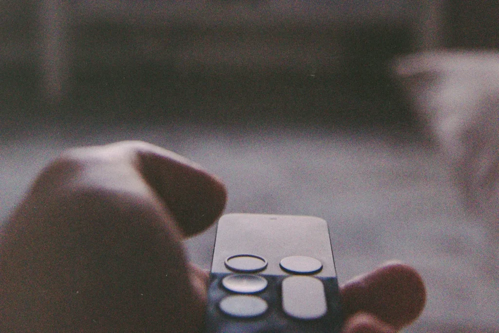 Hand holding smart tv remote