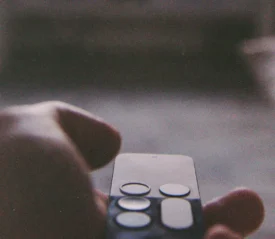 Hand holding smart tv remote