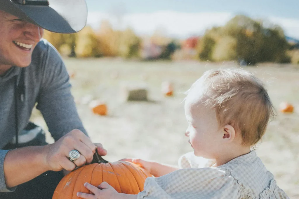 Little baby grabbing a pumpkin