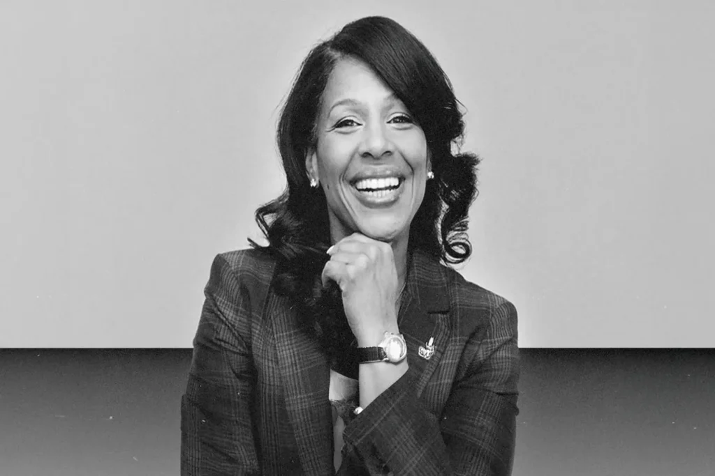 Tamaira Sandifer posing with her hand under her chin and smiling