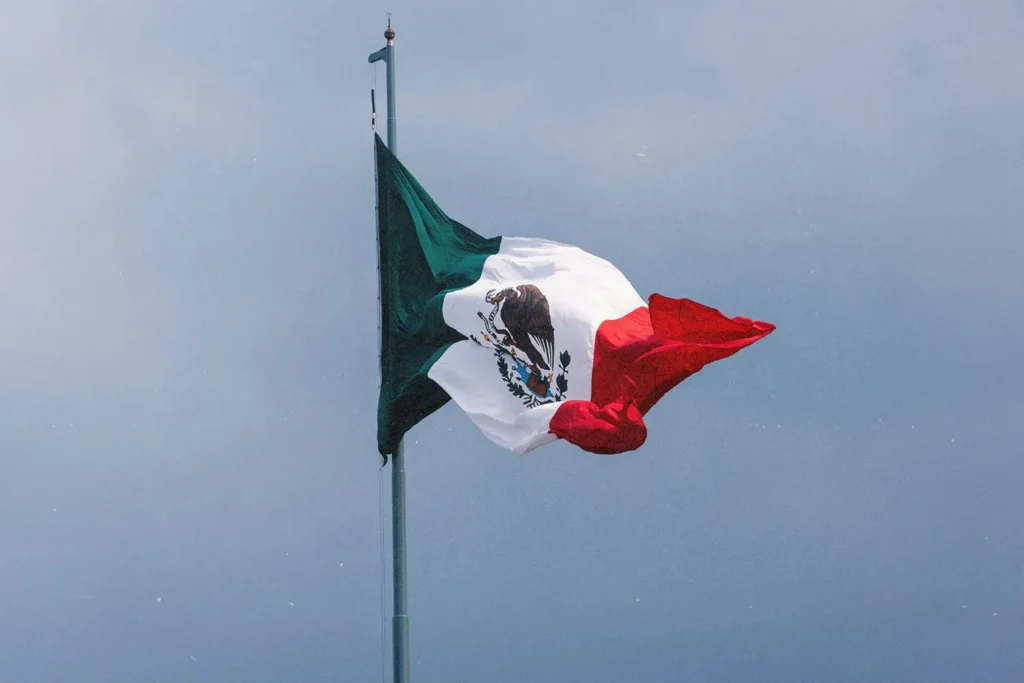 Mexico flag flying with clear sky in the background