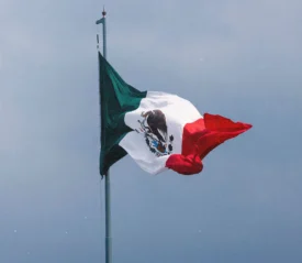 Mexico flag flying with clear sky in the background