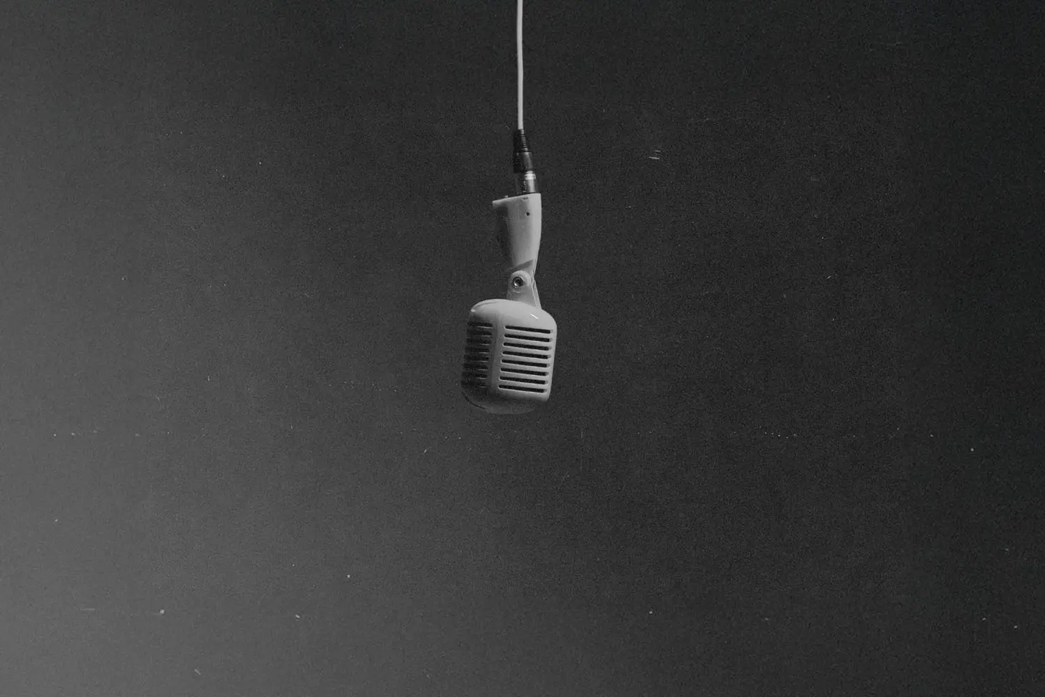 Single microphone hanging from cord