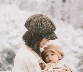 mother holding a child in the snow