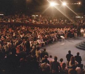 Audience of people watching Kenneth Copeland preach from stage at Southwest Believers' Convention