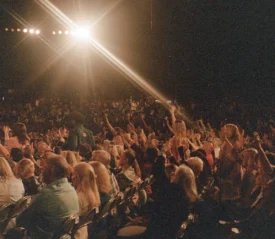 Crowd of people with their hands raised