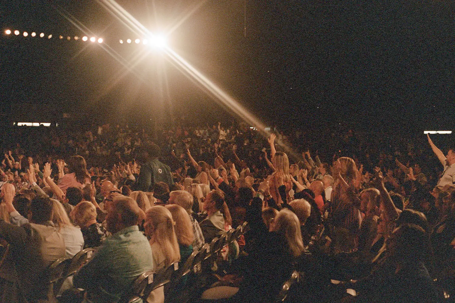 Crowd of people with their hands raised
