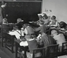Classroom full of students at their desks with a teacher in the front