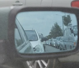 Rearview mirror showing cars in traffic, symbolizing gratitude and perspective in life’s waiting seasons.