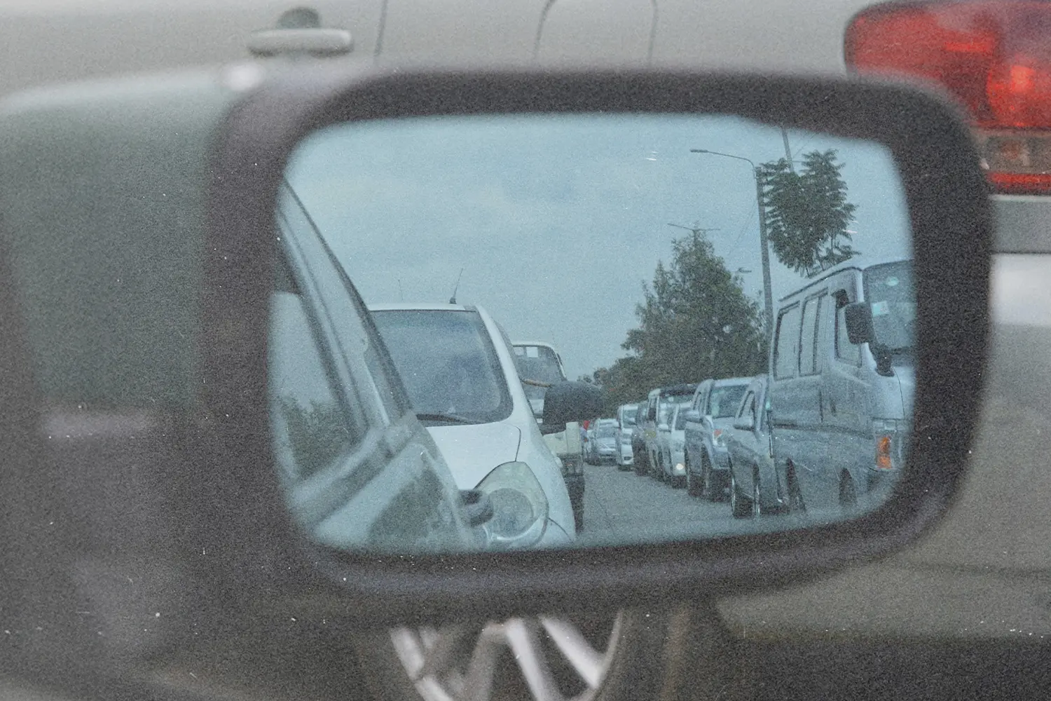 Rearview mirror showing cars in traffic, symbolizing gratitude and perspective in life’s waiting seasons.