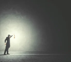 An illustration of a man holding a lantern searching in the fog