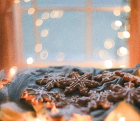Festive Christmas cookies on a tray with glowing lights near a window, reminding us to Walk in the Spirit and embrace peace during the holiday season.
