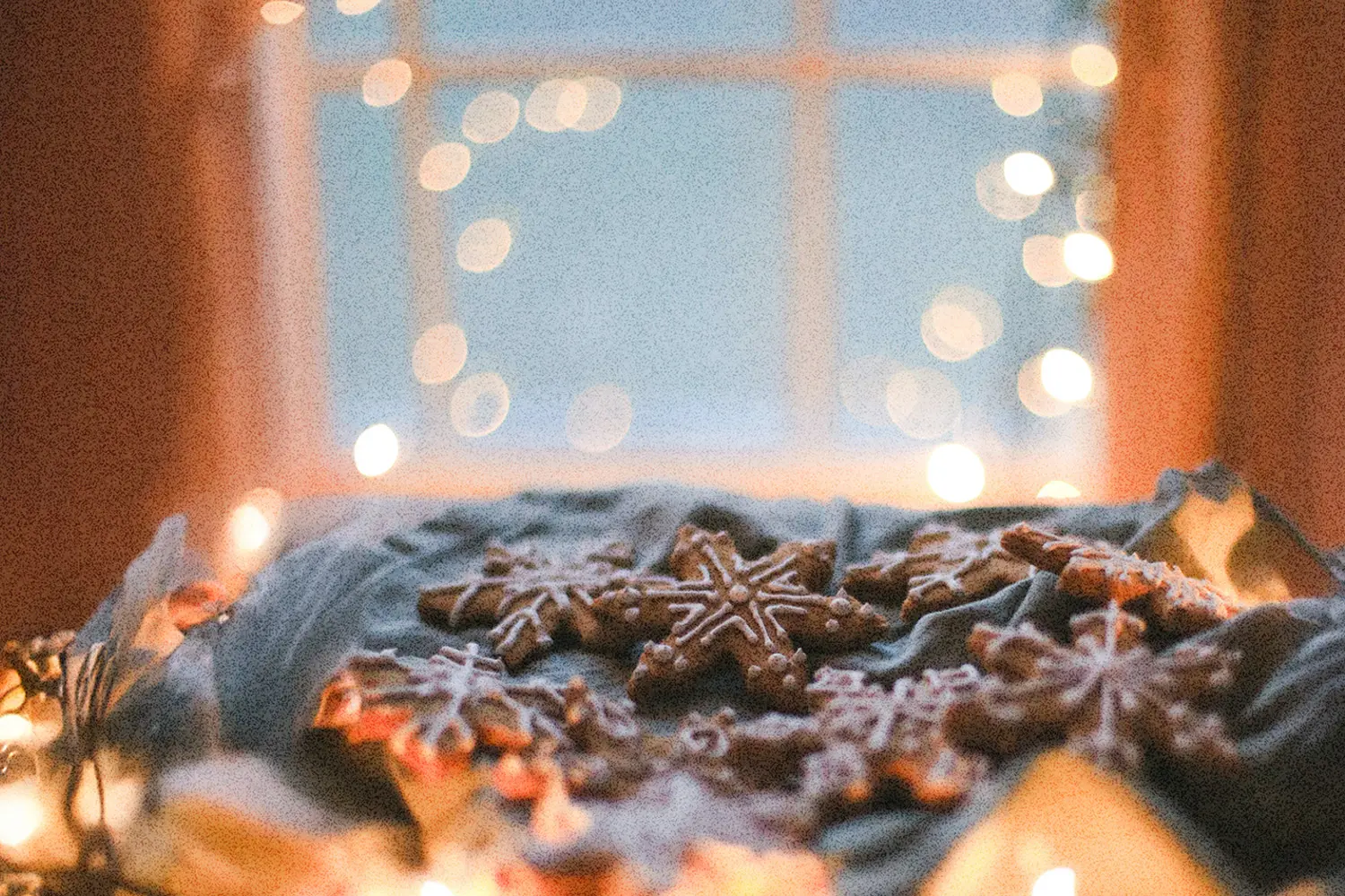 Festive Christmas cookies on a tray with glowing lights near a window, reminding us to Walk in the Spirit and embrace peace during the holiday season.