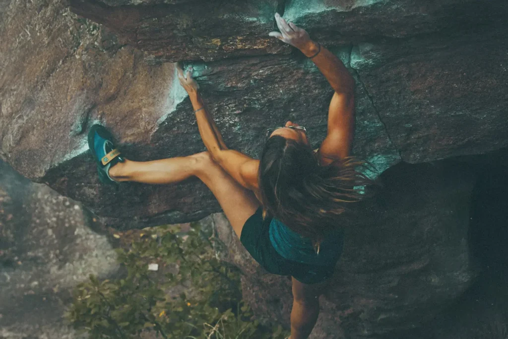 A rock climber climbing a mountain, showing becoming Strong in Covenant Faith