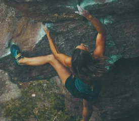 A rock climber climbing a mountain, showing becoming Strong in Covenant Faith