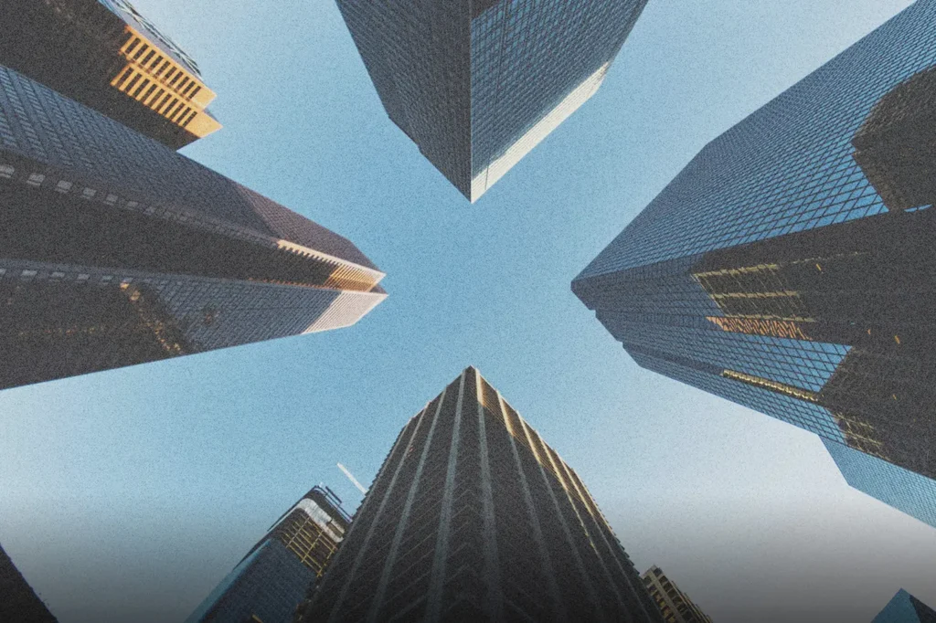 Perspective view of tall city buildings rising upward, symbolizing God’s path to financial provision through faith, obedience, stewardship, and spiritual growth.