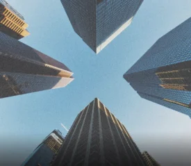 Perspective view of tall city buildings rising upward, symbolizing God’s path to financial provision through faith, obedience, stewardship, and spiritual growth.